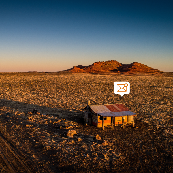 A shack in the outback with an email logo above it